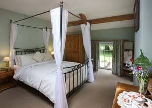 Four Poster Bed on Historic Plas Cilybebyll Estate Historic Holiday Cottages - Y Stabl Master Bedroom